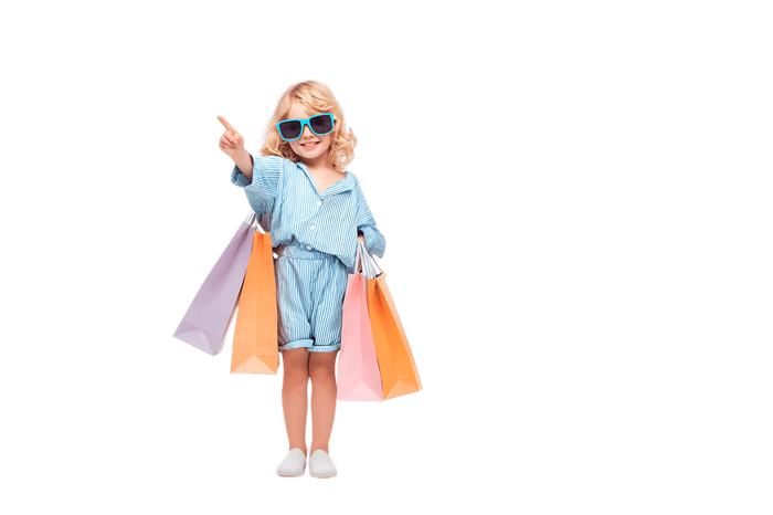 Cute girl with shopping bags, pointing. Retail, shopping, consumerism concept.