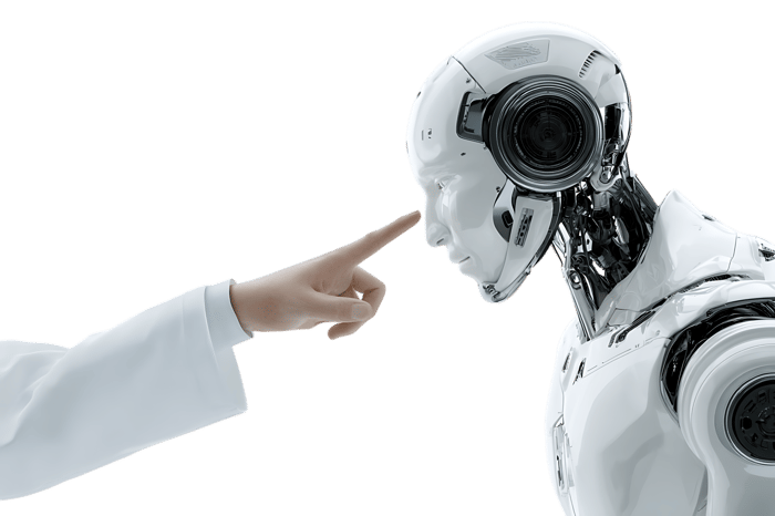 Human hand pointing at a robot's face.
