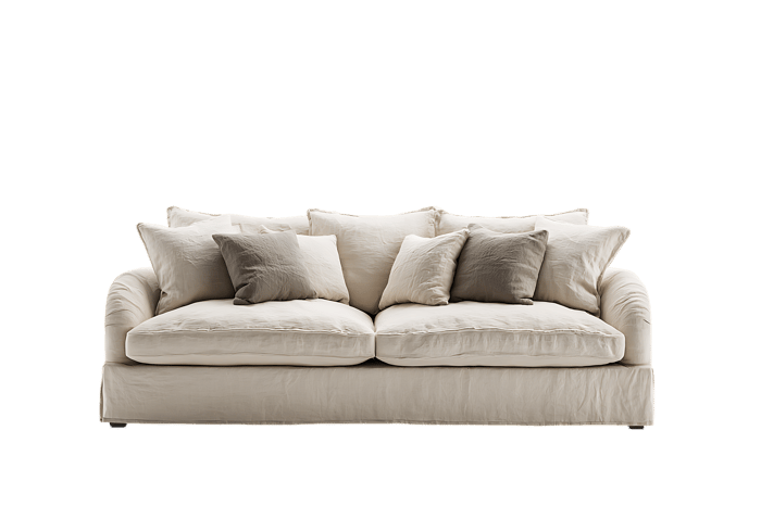 Cream colored sofa with pillows, isolated on black background.