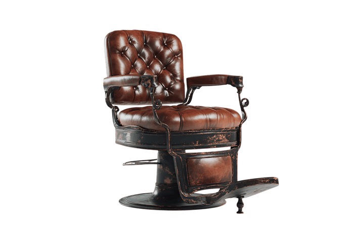 Vintage barber chair, brown leather, isolated on black.