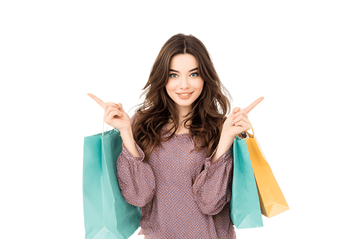 Happy woman with shopping bags pointing sideways