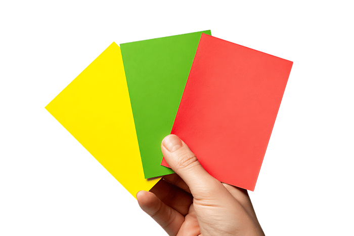 Hand holding a set of referee cards,  yellow, green, red. Sports concept.