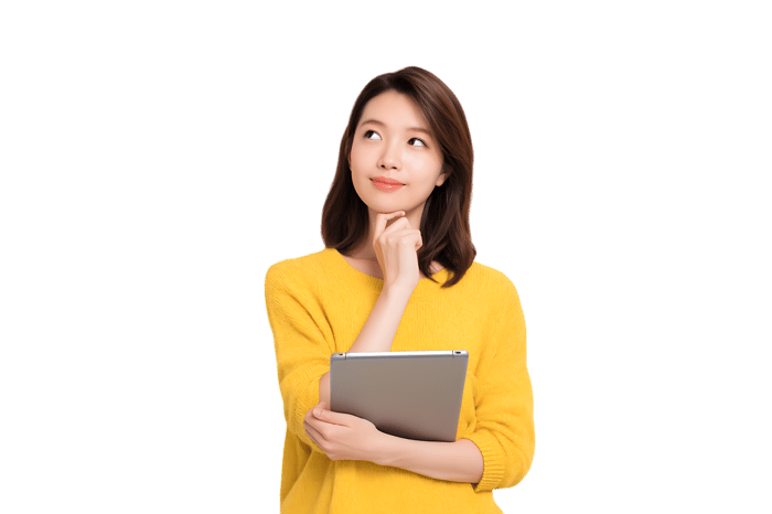 Young woman in yellow sweater holding tablet, deep in thought.