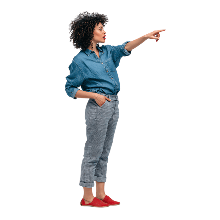 Confident woman pointing, isolated on black.