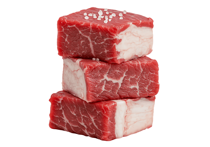 Stack of fresh beef cubes, seasoned with salt.