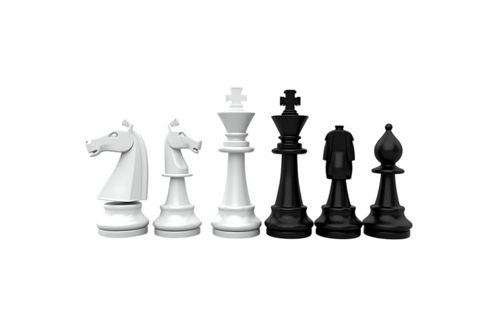 Contrasting chess pieces arranged on white background, symbolizing strategy and opposition in business or life