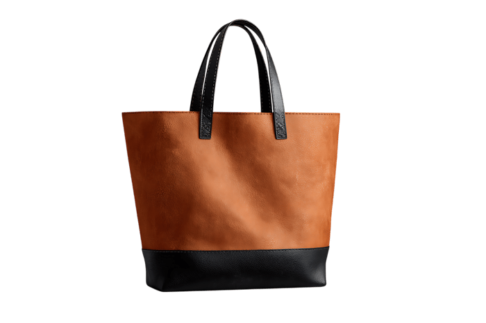Stylish brown and black tote bag isolated on black background