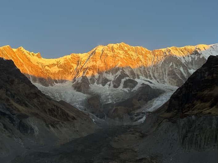 Sunlit golden snow-capped mountain peaks