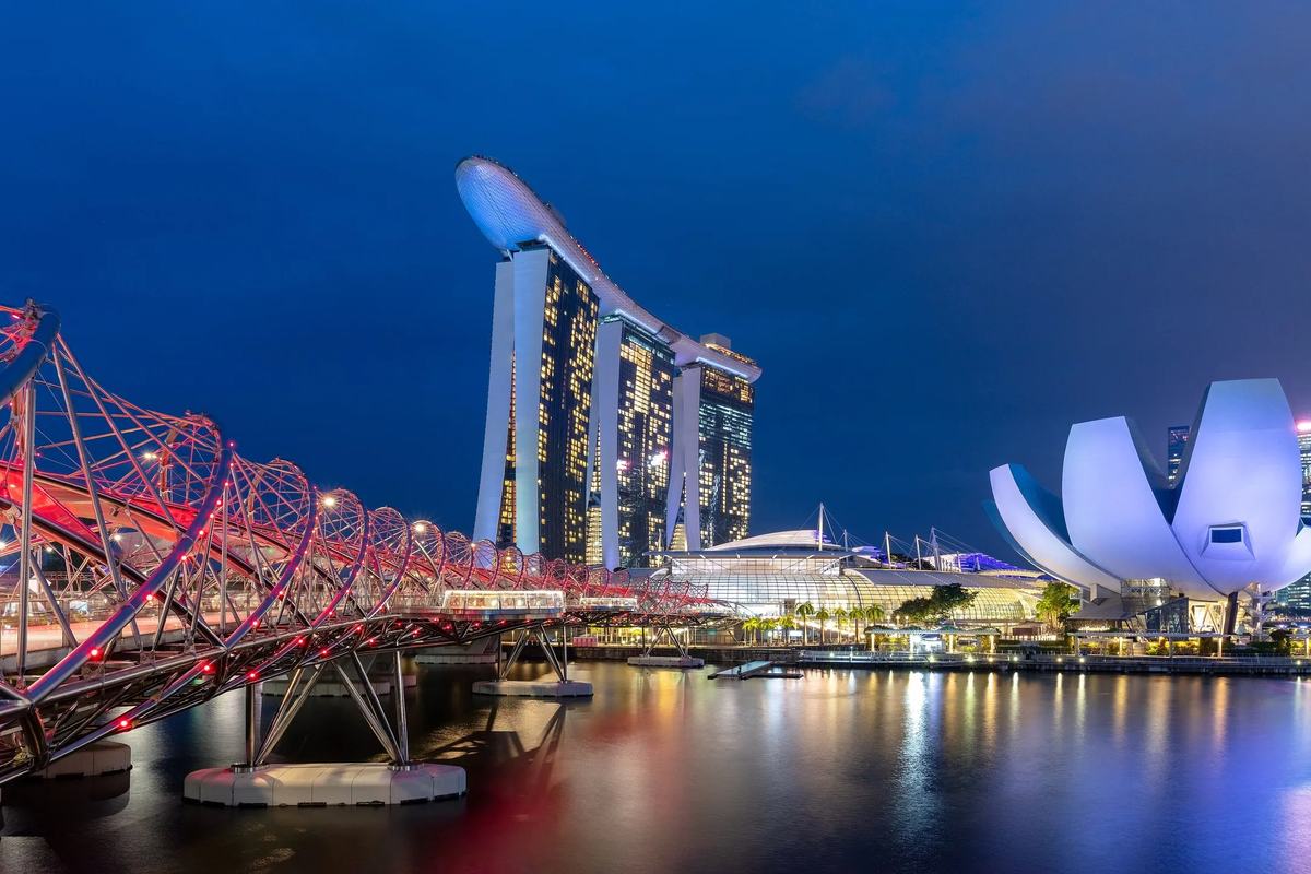 The Helix Bridge, Marina Bay Sands and the ArtScience Museum across Marina Bay at dusk, Singapore