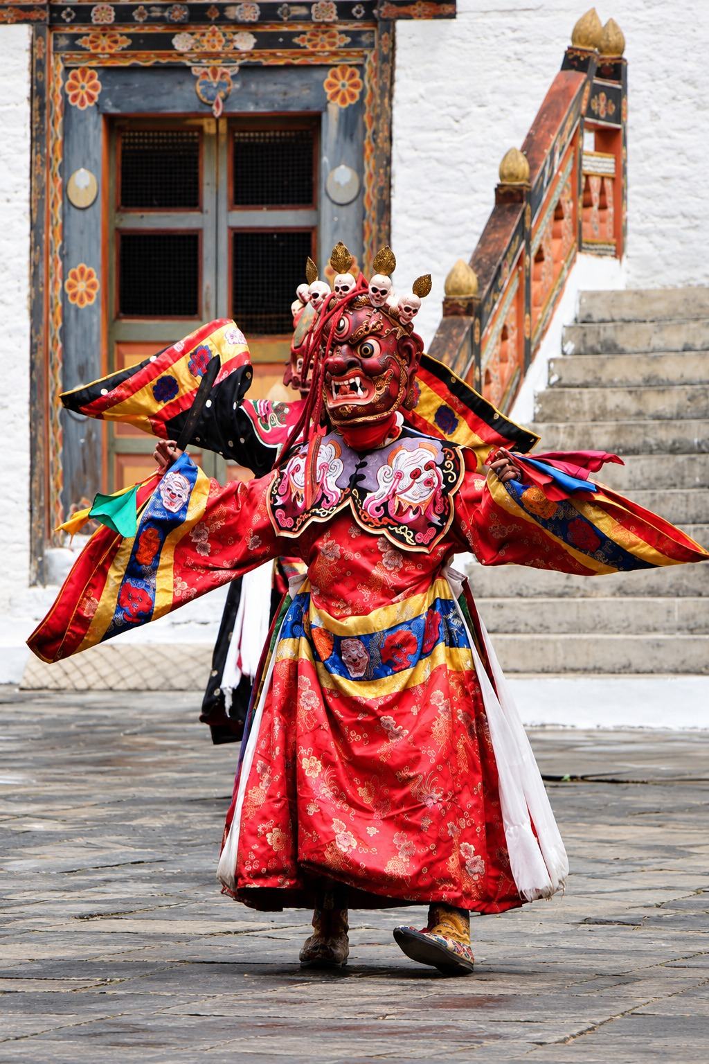 A cham dancer in a dzong courtyard