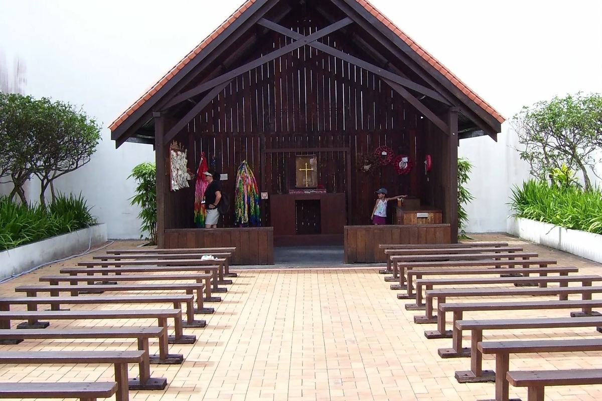 The open-air Changi Chapel, with its timber altar and rows of wooden benches, Singapore