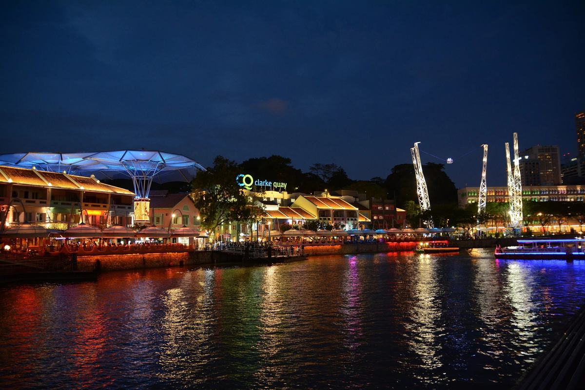 Clarke Quay's riverside restaurants lit up at night on the Singapore River
