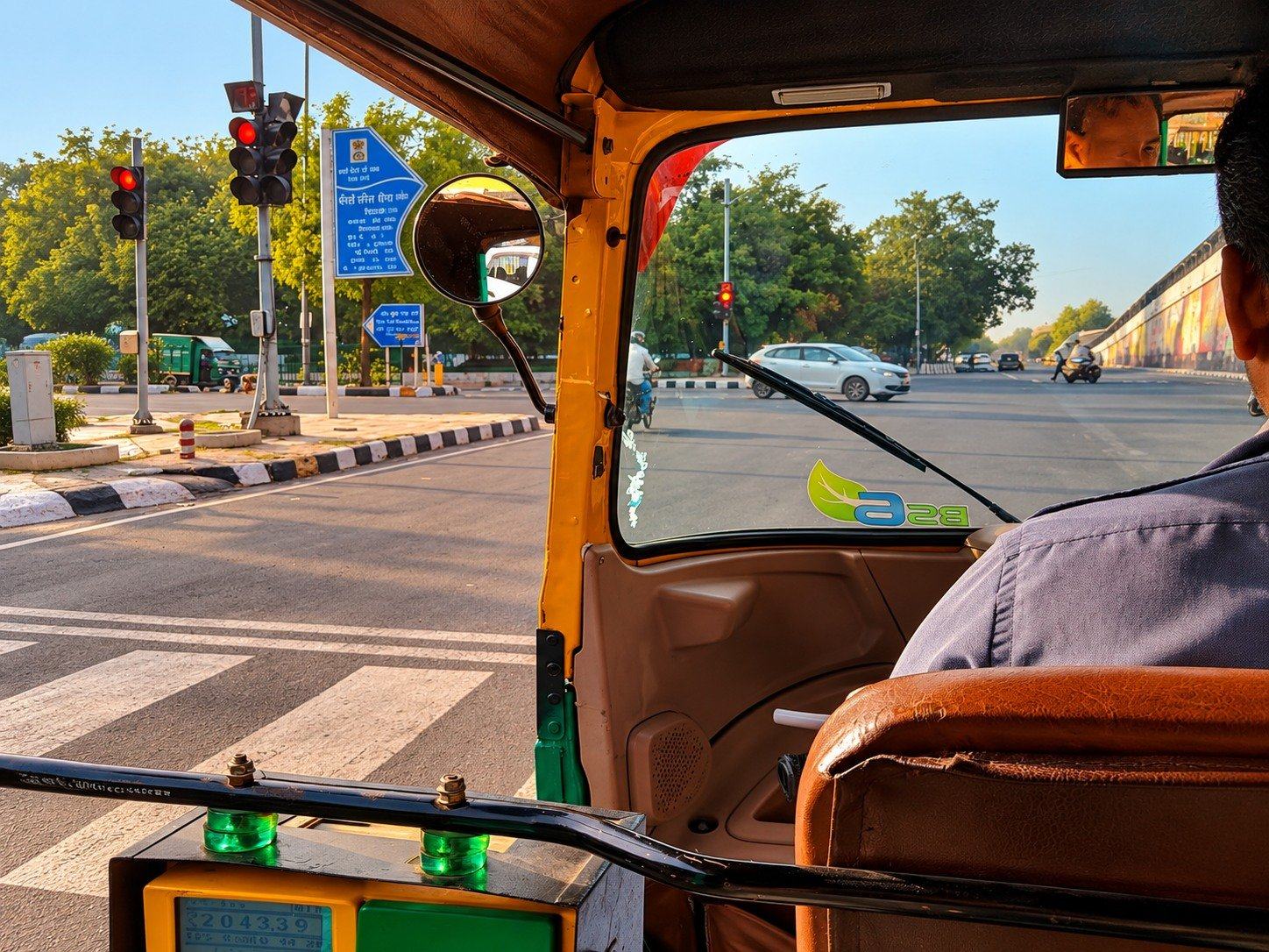 An auto rickshaw at the lights