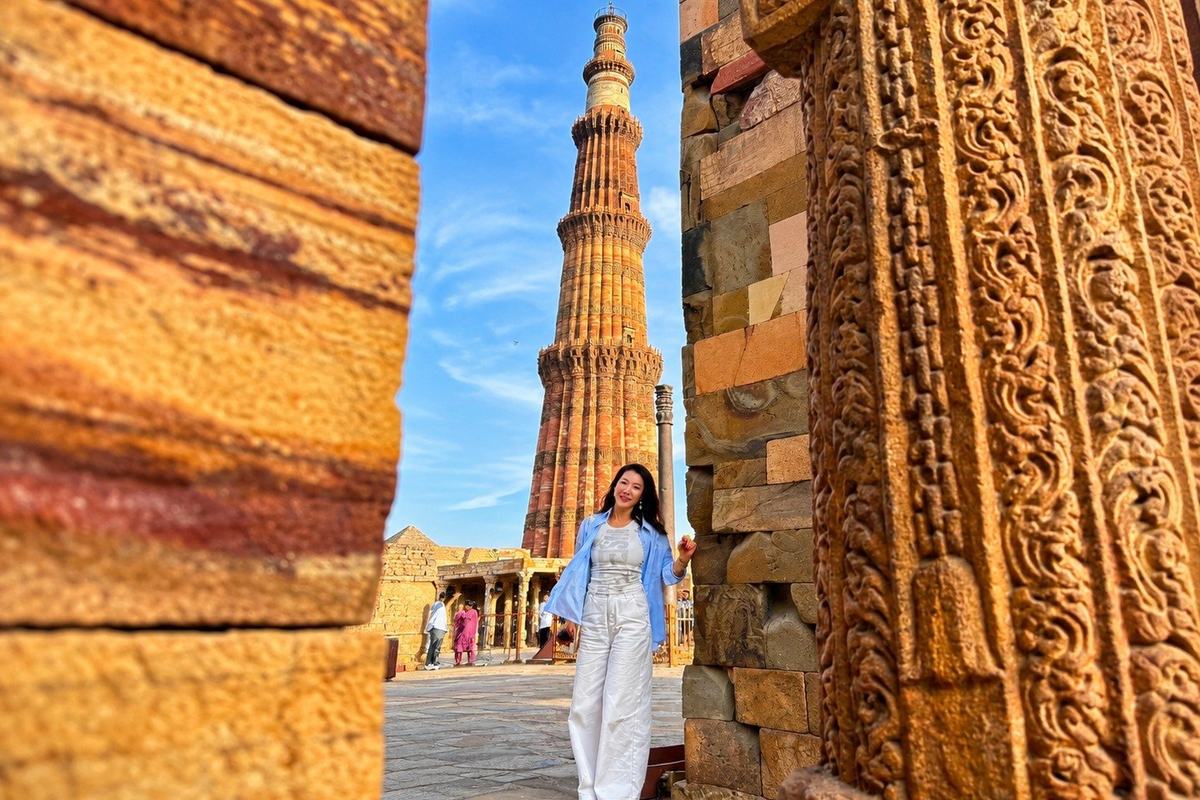 A traveller among the ruins at Qutub Minar, Delhi, India