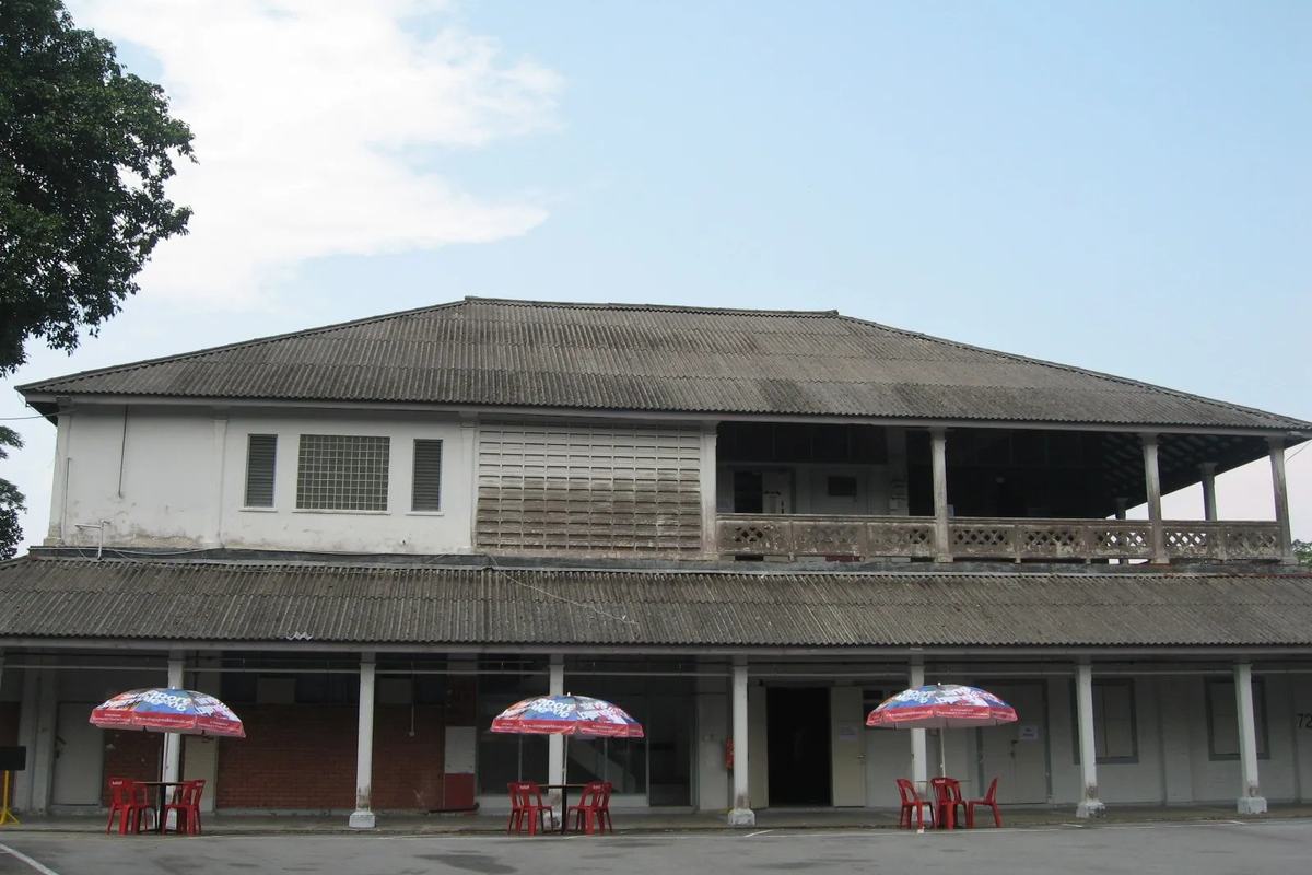 A two-storey former barracks with café umbrellas at Dempsey Hill, Singapore