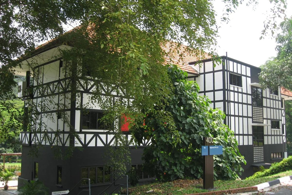 A black-and-white timbered building among the trees of Dempsey Hill, Singapore