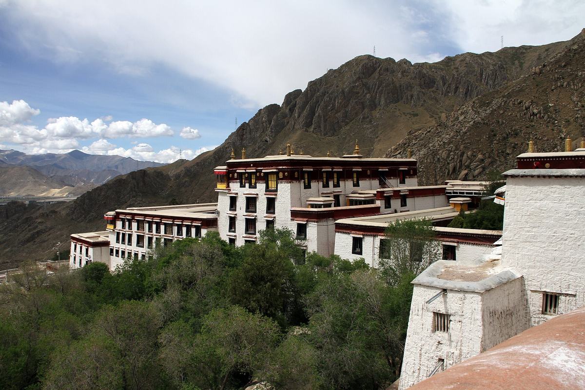 Drepung Monastery's white buildings on the hillside west of Lhasa, Tibet