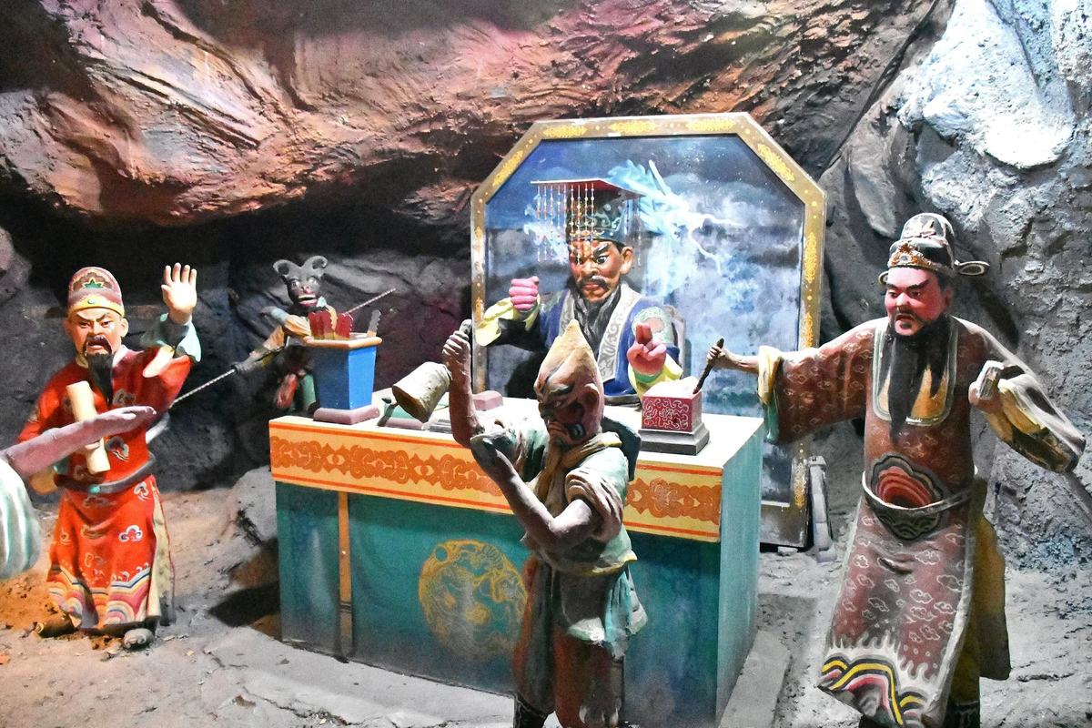 Painted figures of judges and demons in a diorama at Haw Par Villa, Singapore