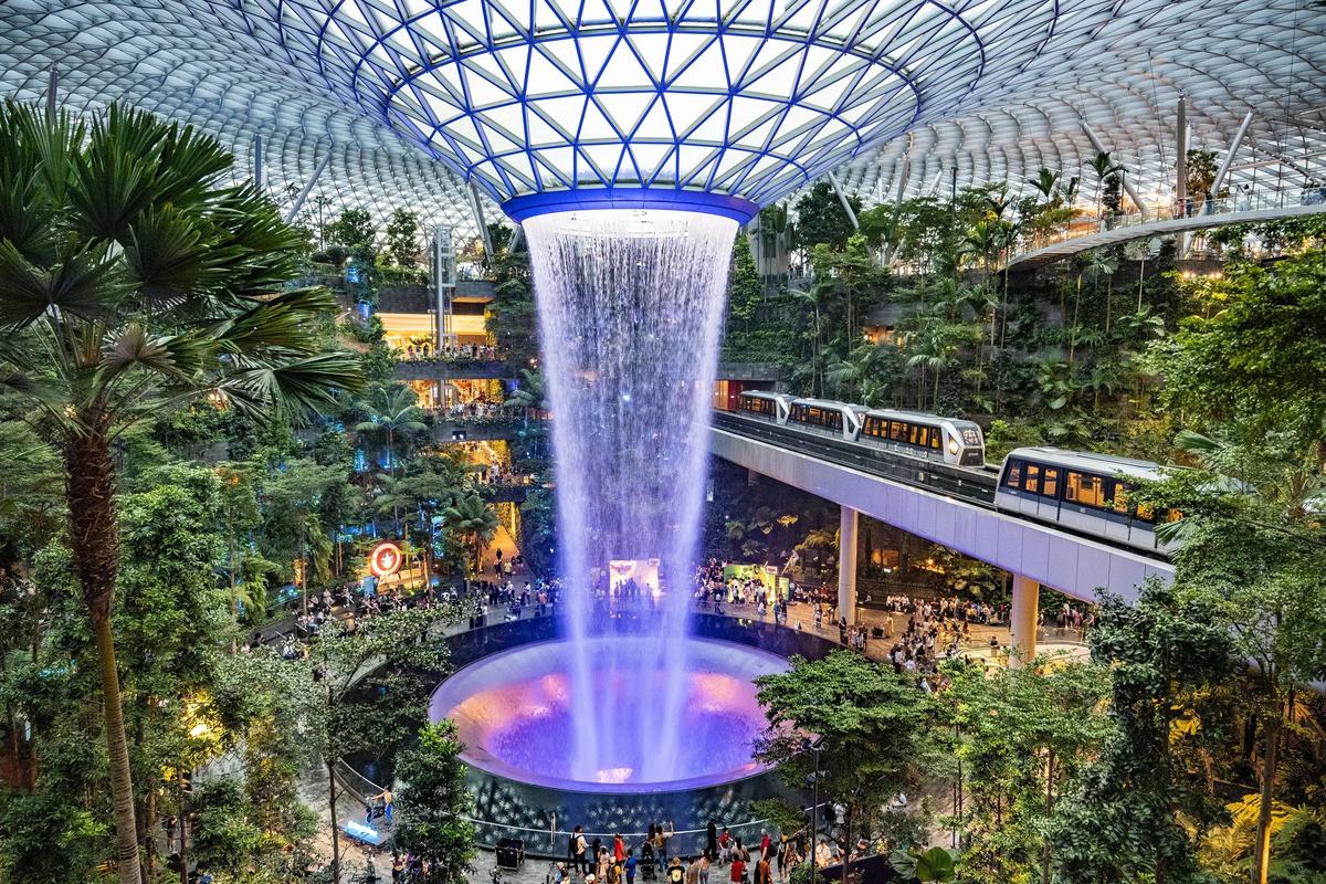 The Rain Vortex at Jewel Changi Airport, with the Skytrain passing, Singapore