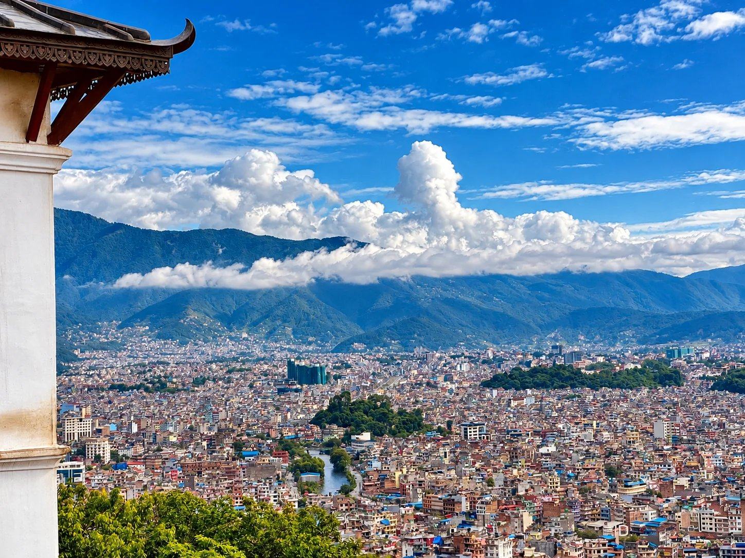 The Kathmandu Valley cityscape under mountain clouds, seen from a hilltop temple, Nepal