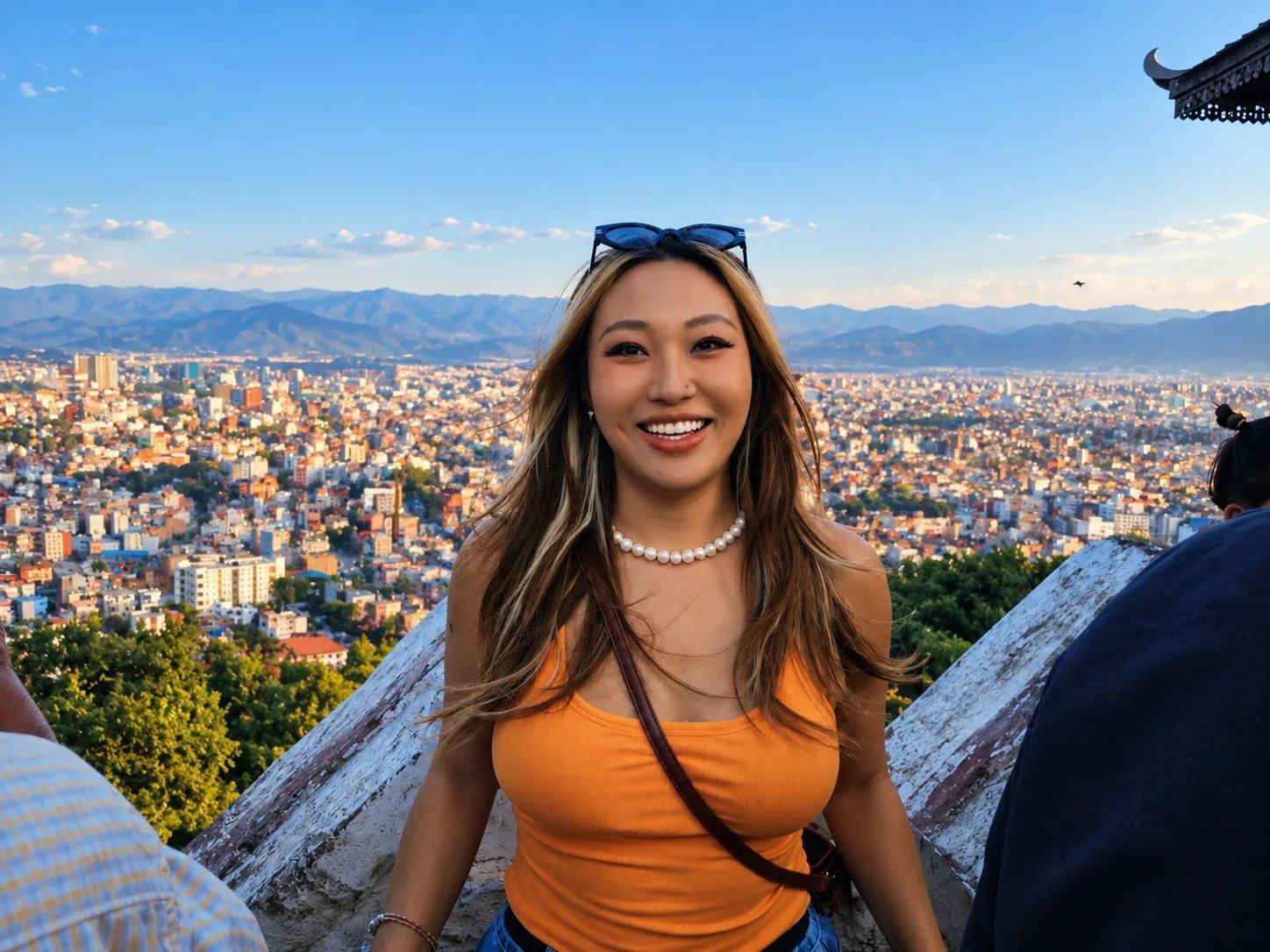 A smiling traveller above the Kathmandu Valley cityscape from a hilltop stupa, Nepal