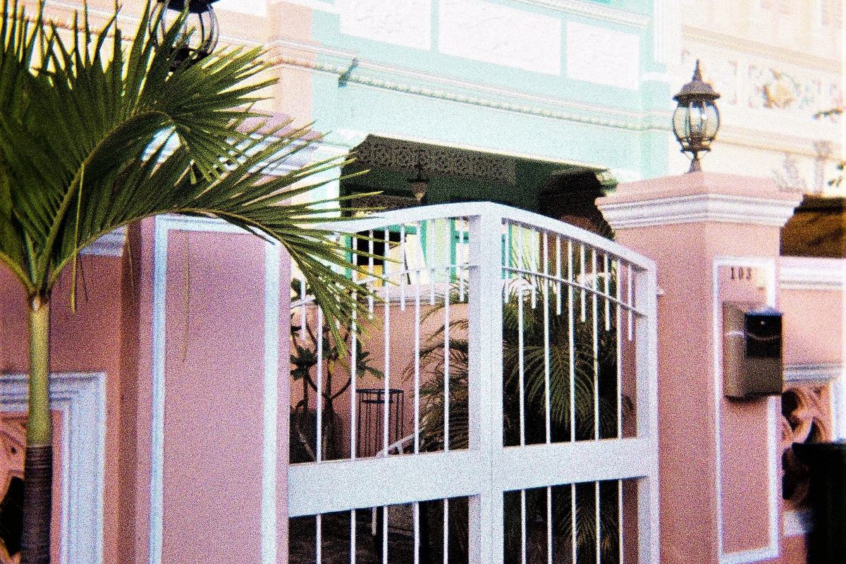 A pastel Peranakan terrace house with a white gate in Joo Chiat, Singapore