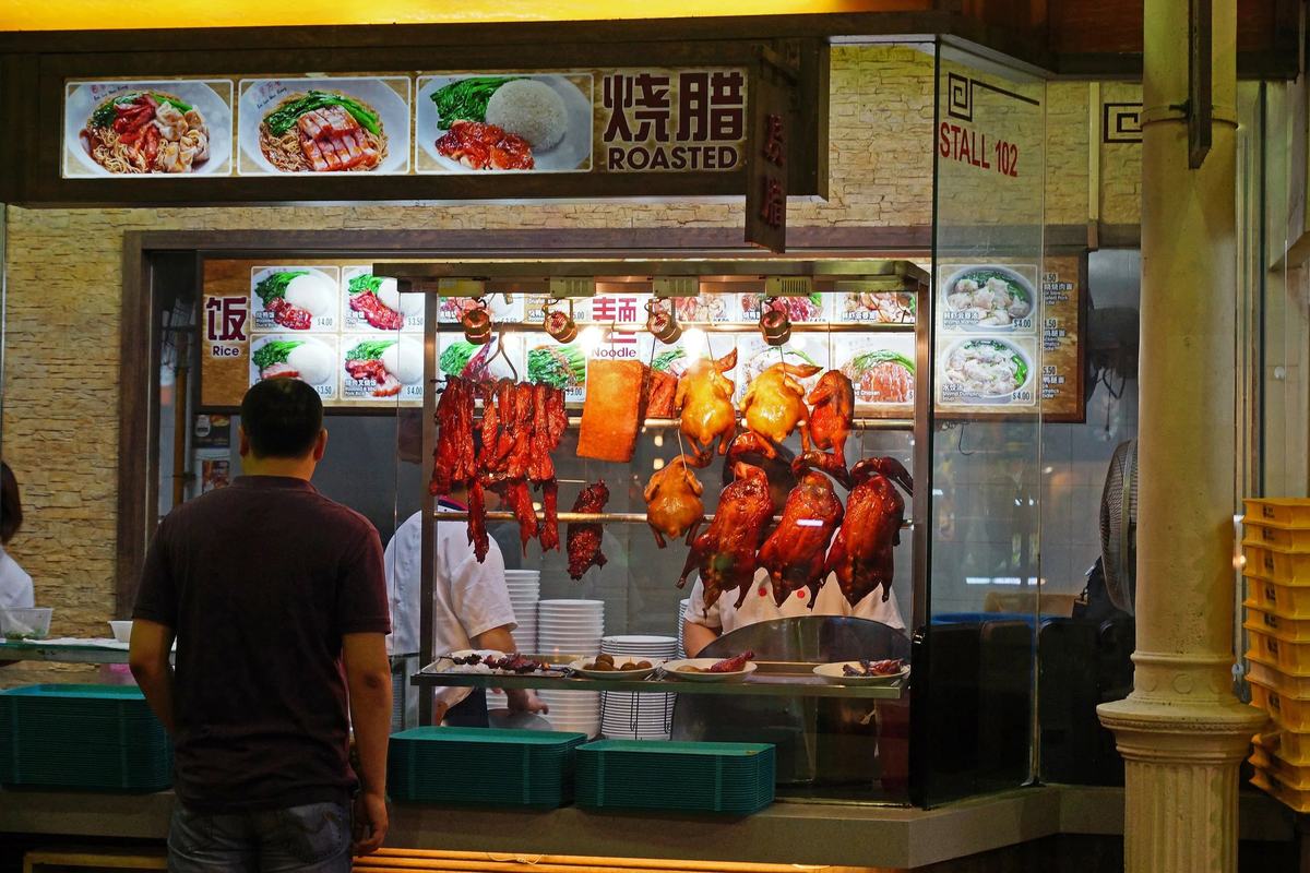 Roast duck and char siu hanging at a stall inside Lau Pa Sat, Singapore