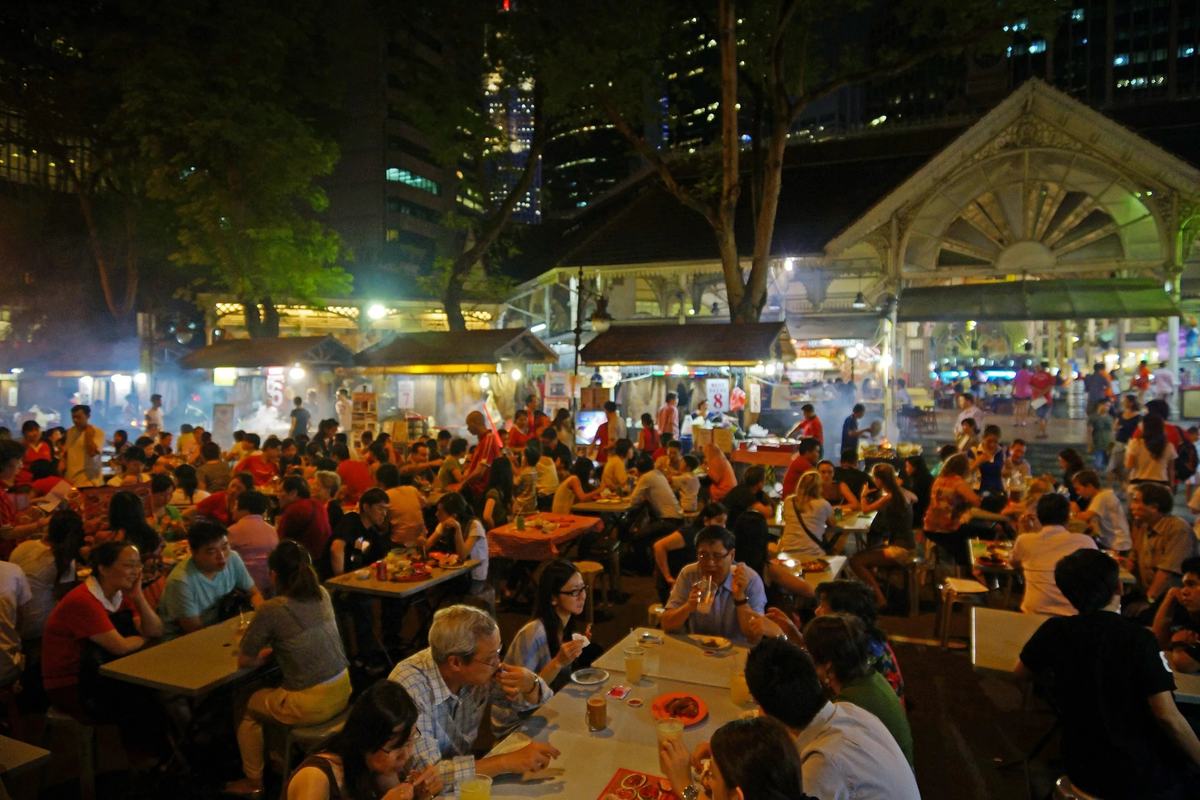 Diners at the satay street tables outside Lau Pa Sat at night, Singapore