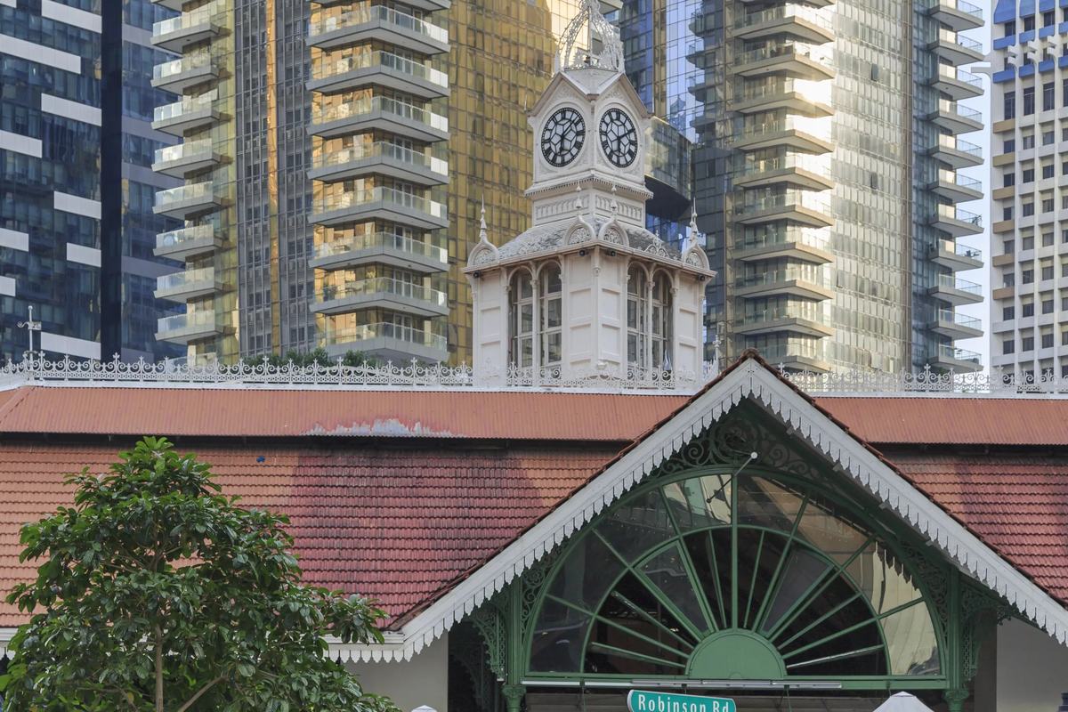 Lau Pa Sat's clock tower and cast-iron entrance below the city towers, Singapore