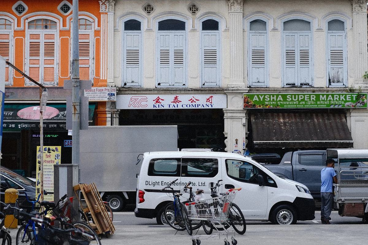 Shuttered shophouses and a parked bicycle on a Little India street, Singapore