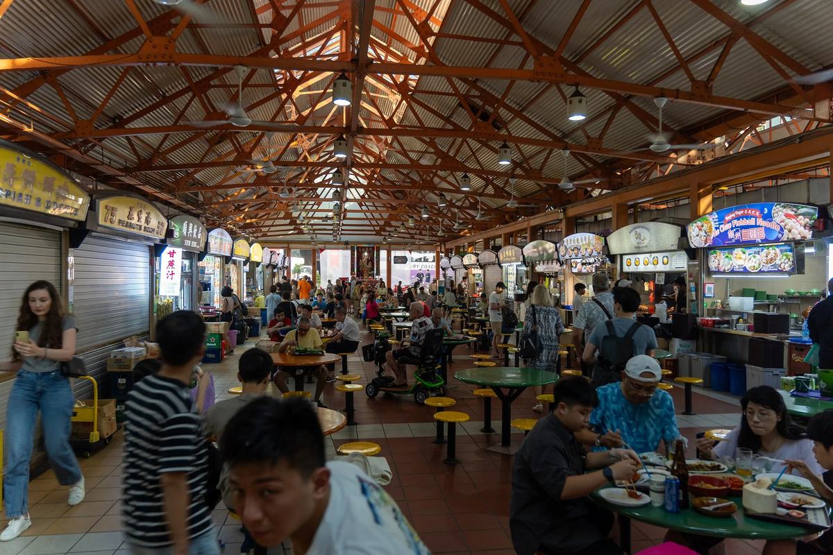 Hawker stalls and diners under the roof of Maxwell Food Centre, Singapore
