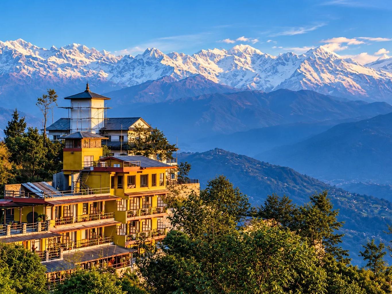 A hilltop hotel among pine trees facing the snow-capped Himalayas, Nepal