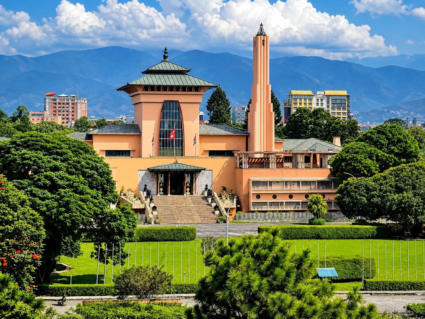Narayanhiti Palace Museum, the former royal palace of Nepal, with its pagoda-roofed hall, tall tower, gardens and the hills behind, Kathmandu, Nepal