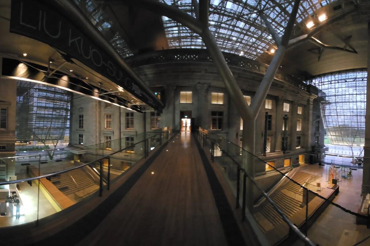 A glass-roofed walkway between the old buildings of the National Gallery, Singapore