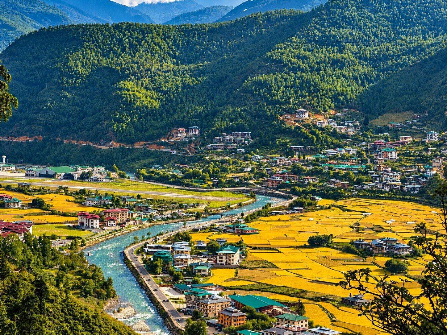 The Paro Chhu river winding through rice fields in the Paro valley, Bhutan
