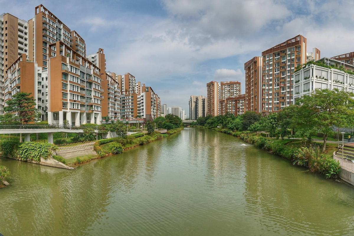 Punggol Waterway flowing between housing blocks and green banks, Singapore