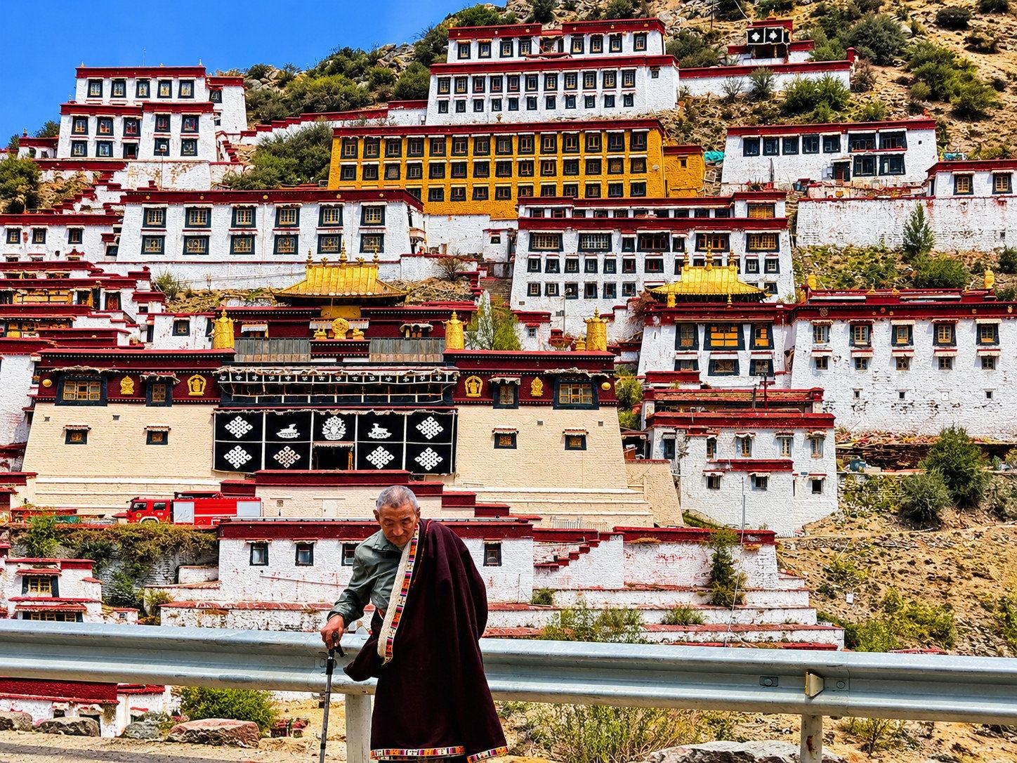 A pilgrim below a hillside monastery