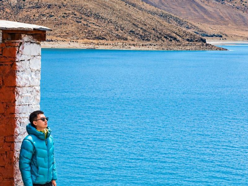 See Yamdrok Lake's turquoise water from the Kamba La pass.
