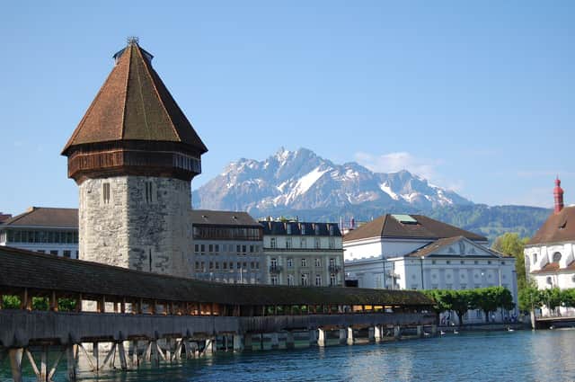 Chapel Bridge and Water Tower in Lucerne with the mountains behind