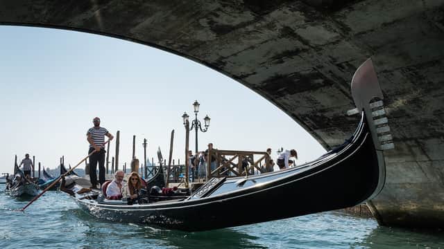 Gondola ride under a bridge in Venice