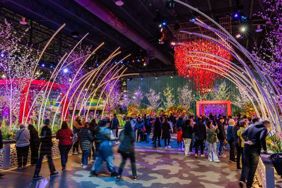 Philadelphia Flower Show interior with towering floral installations and crowds