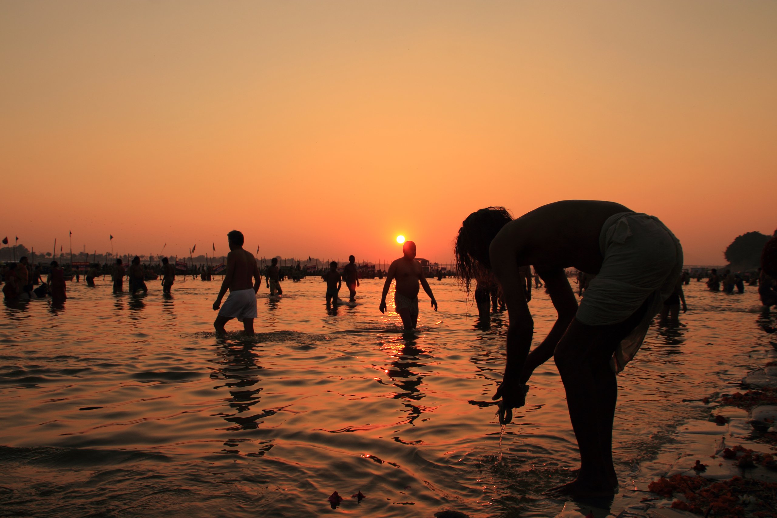 People participating in the holy dip in the River Ganges