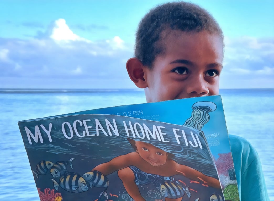 A young child reading an educational book about fiji