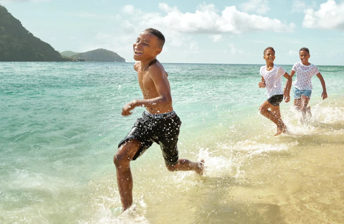 boy runningon beach having fun