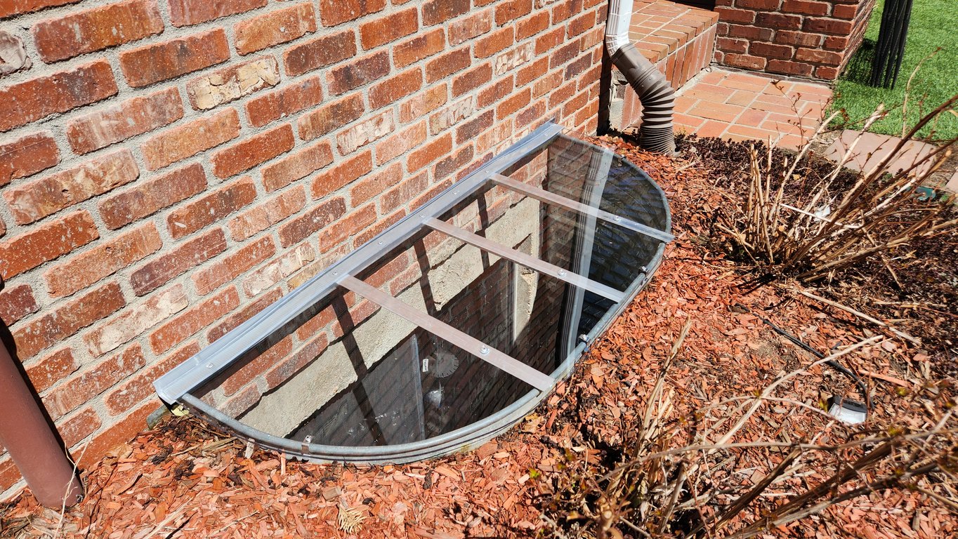UV-protected clear window well cover custom-fabricated on-site in Brookfield Wisconsin
