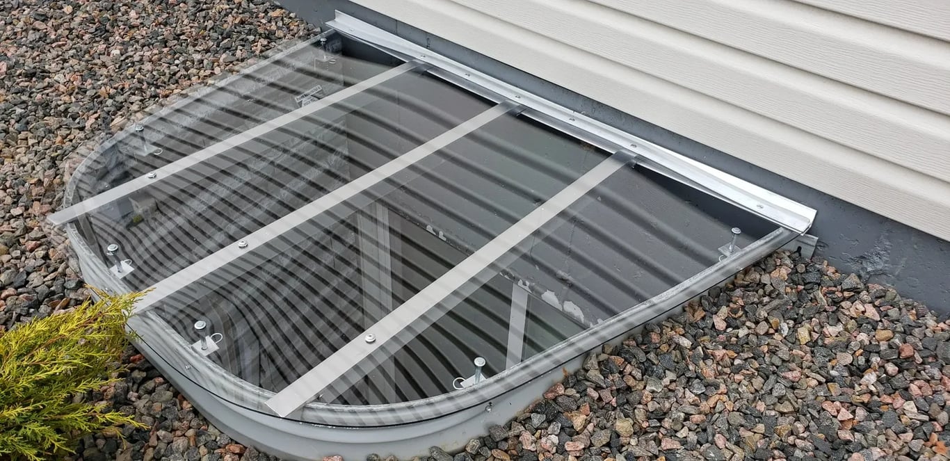 Clear custom polycarbonate window well cover installed in Denver Colorado