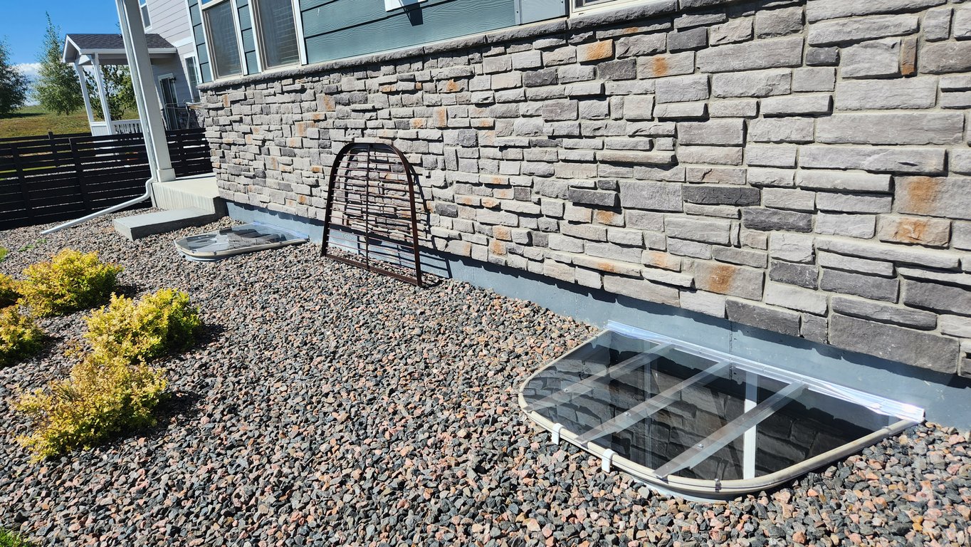 Replacing metal grates with sloped clear polycarbonate window well cover that supports 800 lbs in Federal Heights Colorado