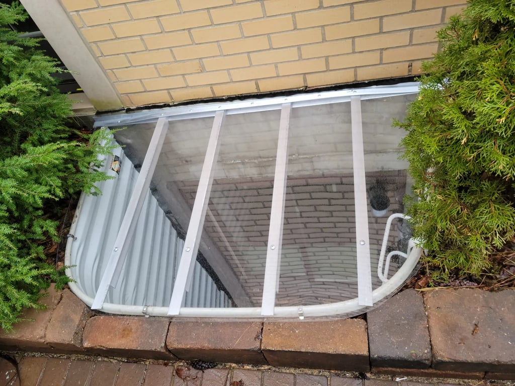 Window well replacement with polycarbonate cover and egress ladder installed in Black Forest Colorado