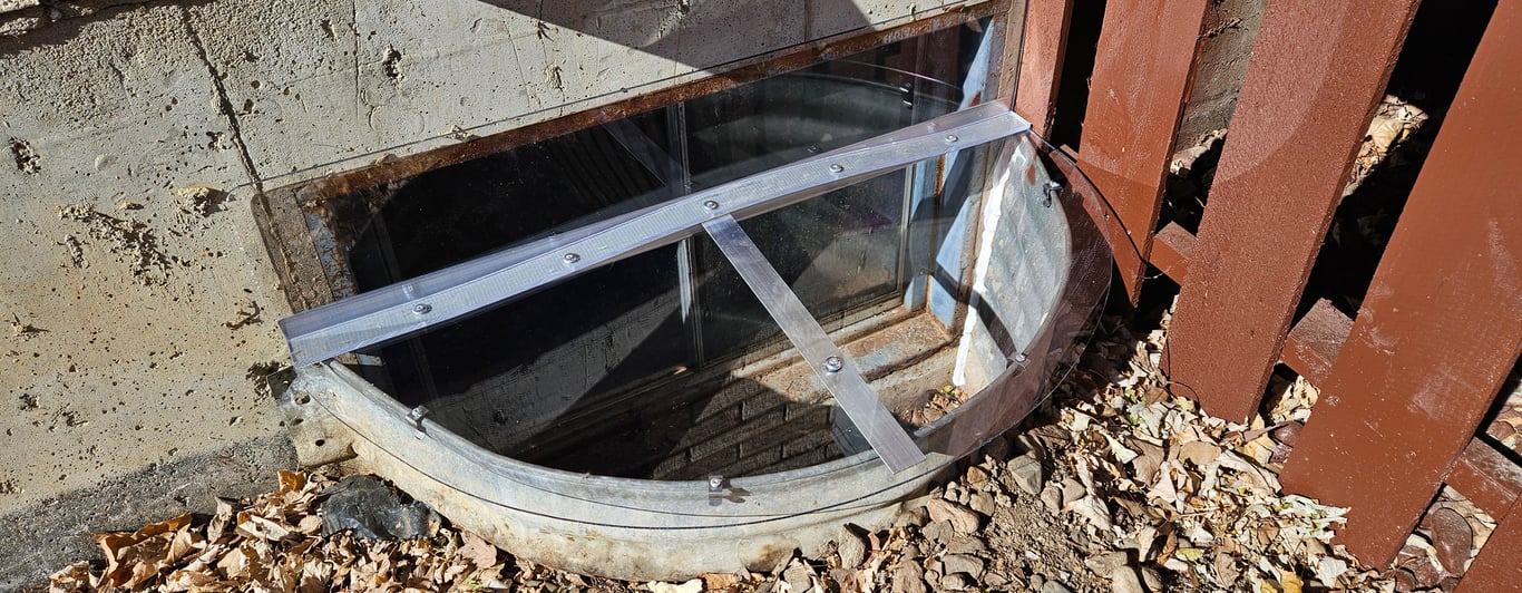Custom made clear window well cover with vertical extension installed in Bolingbrook Illinois with reinforced supports
