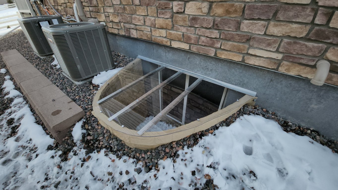 Clear polycarbonate window well cover in Cary Illinois providing safe clean access and protection from debris